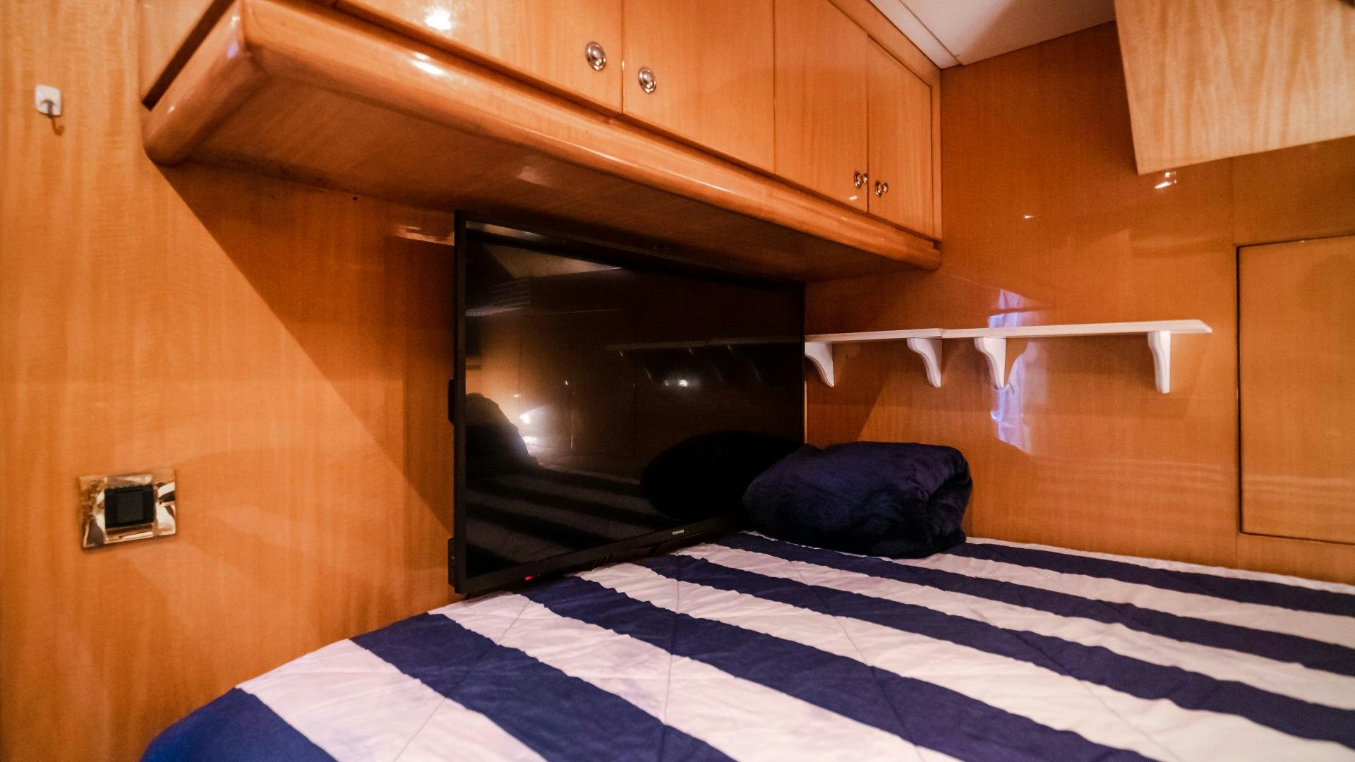 a bed with a black and white checkered blanket aboard VITESSE Yacht for Sale