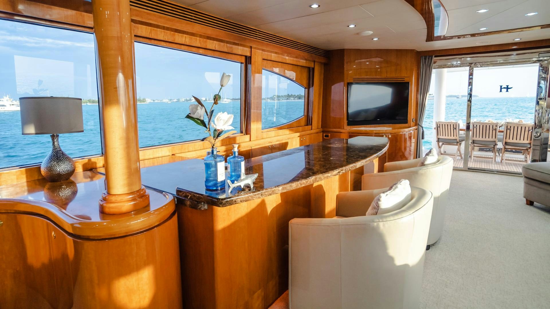 a living room with a large table and a tv aboard VITESSE Yacht for Sale