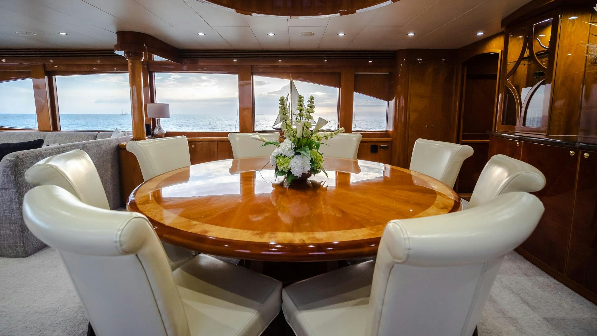 a dining table with chairs and a large window aboard VITESSE Yacht for Sale