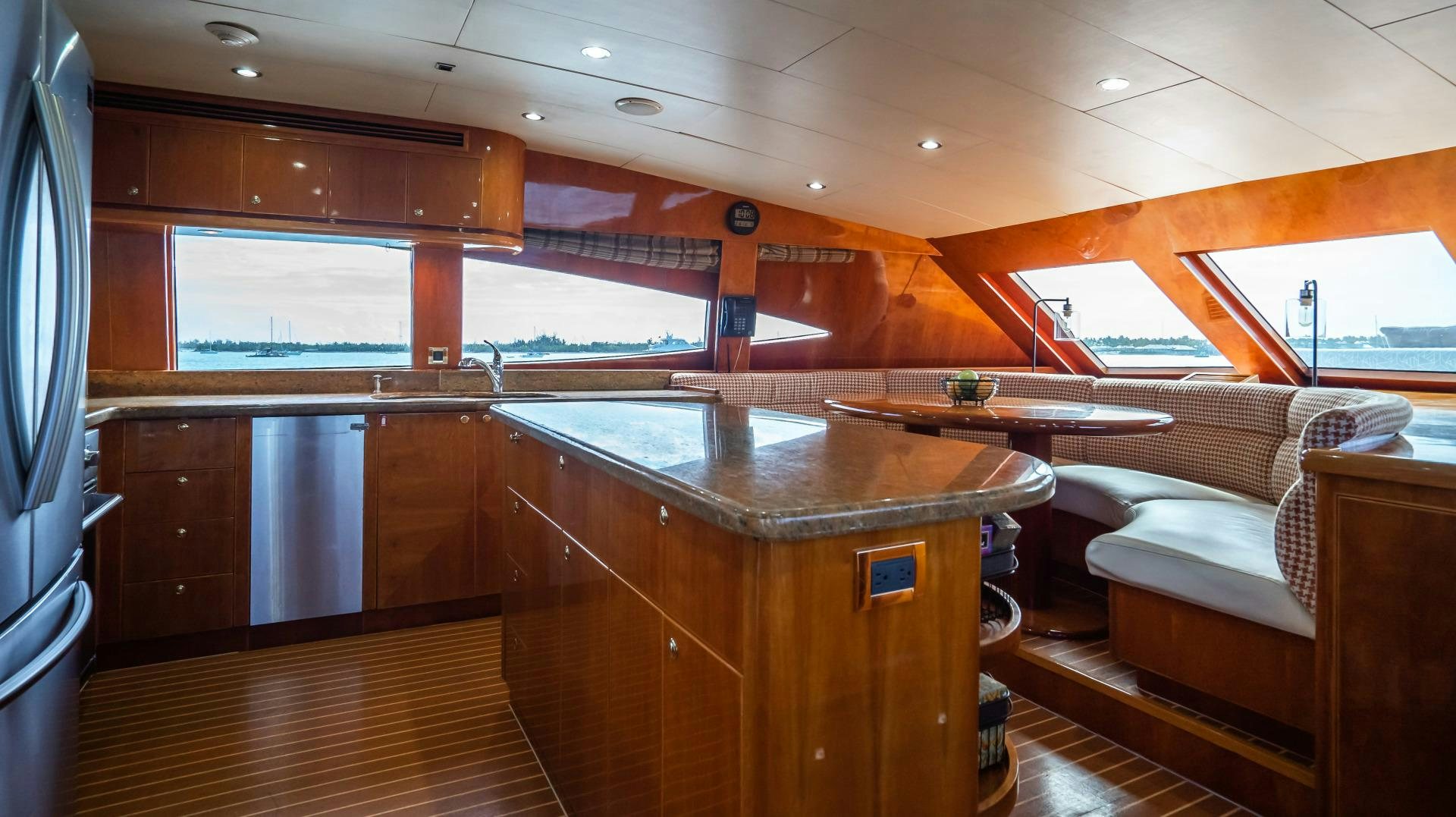 a room with a table and a couch aboard VITESSE Yacht for Sale