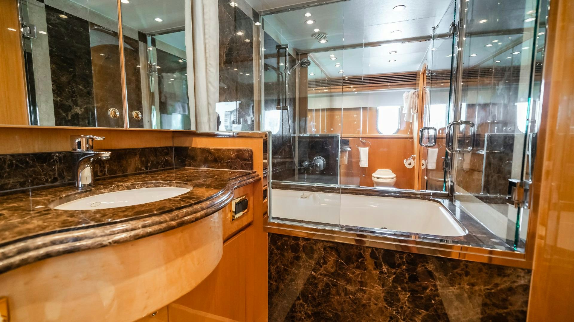 a bathroom with a countertop sink and a large mirror aboard VITESSE Yacht for Sale