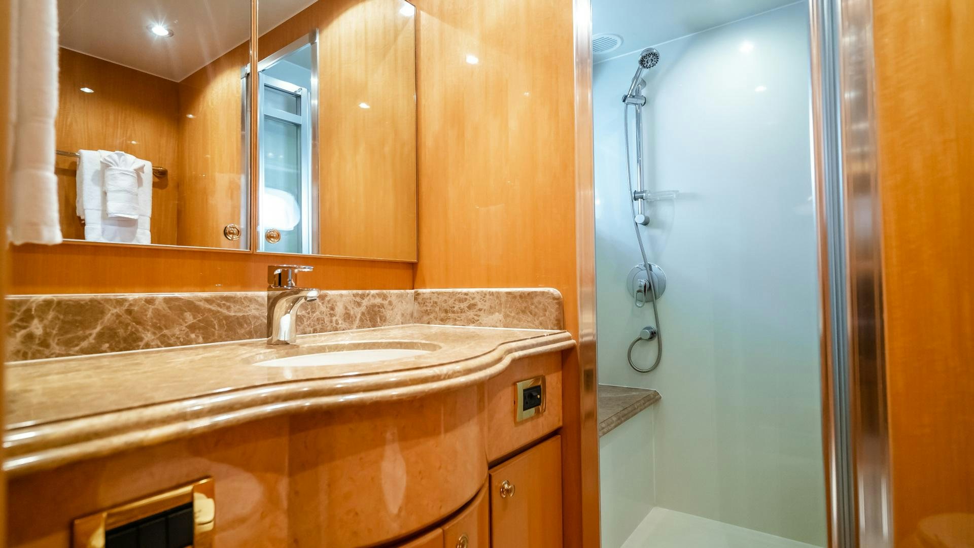 a bathroom with a countertop sink and a shower aboard VITESSE Yacht for Sale
