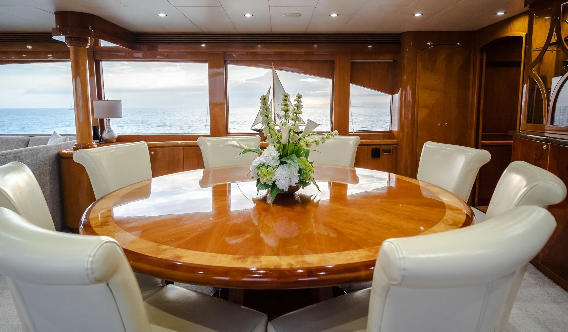 a table with chairs and flowers on it aboard VITESSE Yacht for Sale