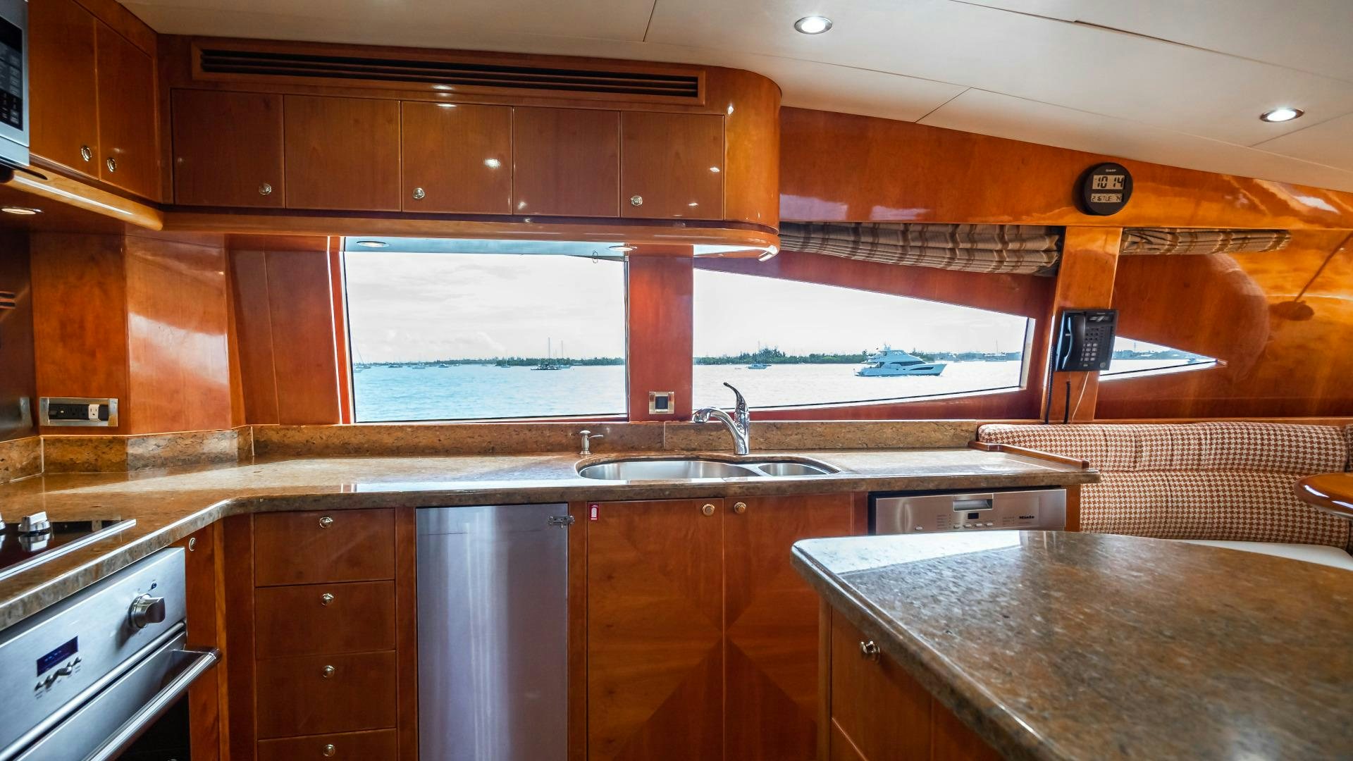 a kitchen with wooden cabinets aboard VITESSE Yacht for Sale
