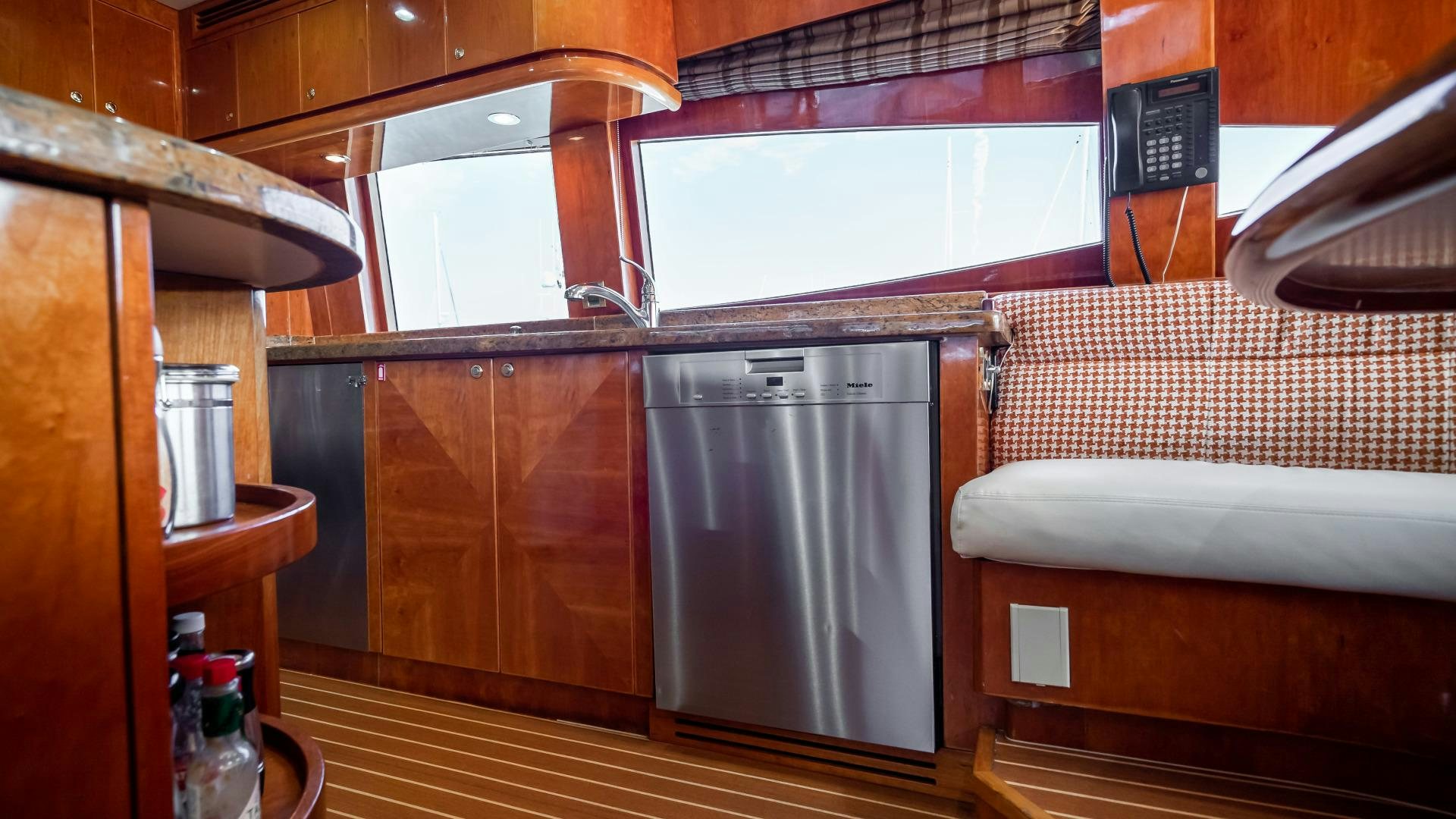 a kitchen with a stainless steel refrigerator aboard VITESSE Yacht for Sale
