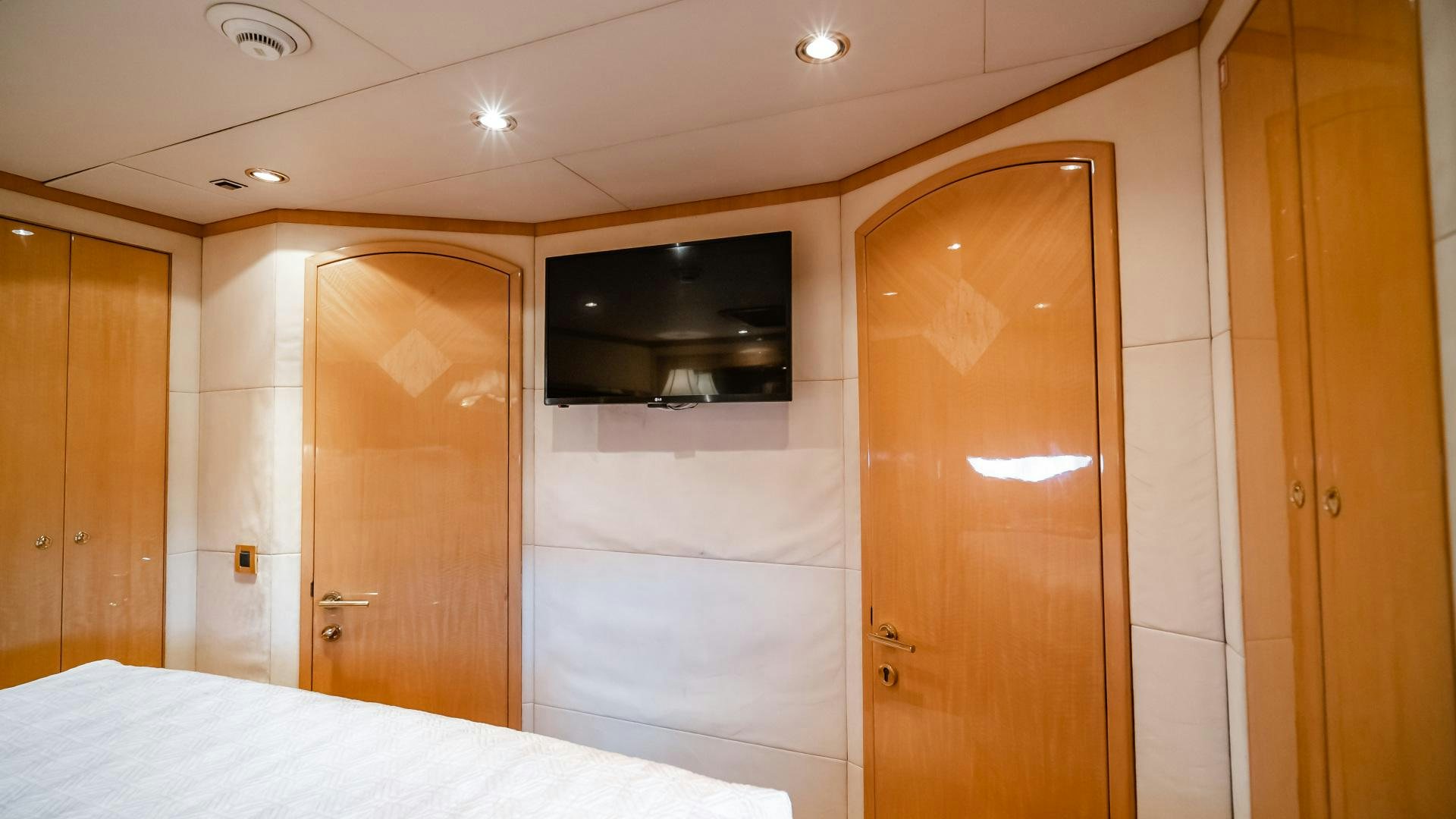a room with a bed and a television on the wall aboard VITESSE Yacht for Sale