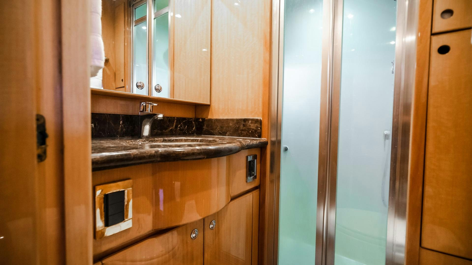 a kitchen with wooden cabinets aboard VITESSE Yacht for Sale