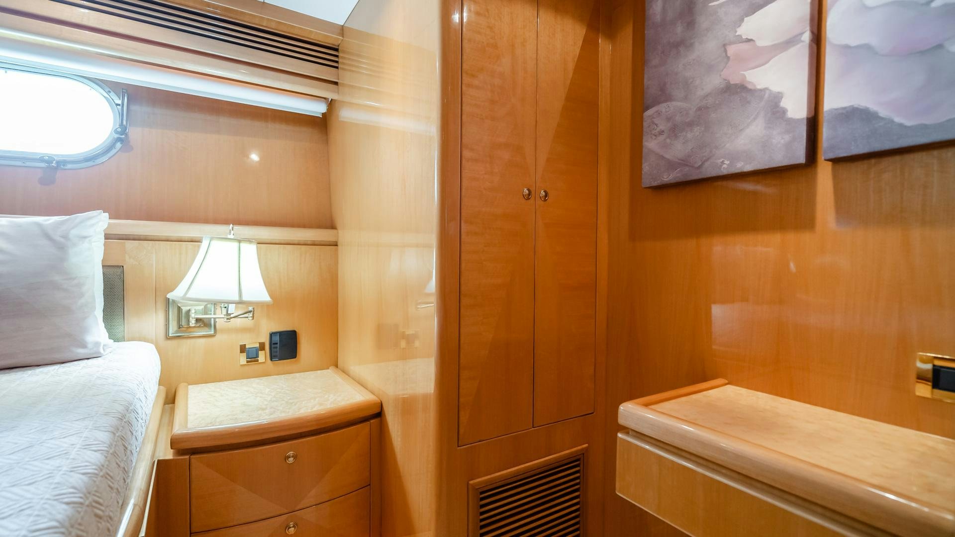 a room with a bed and a wood cabinet aboard VITESSE Yacht for Sale