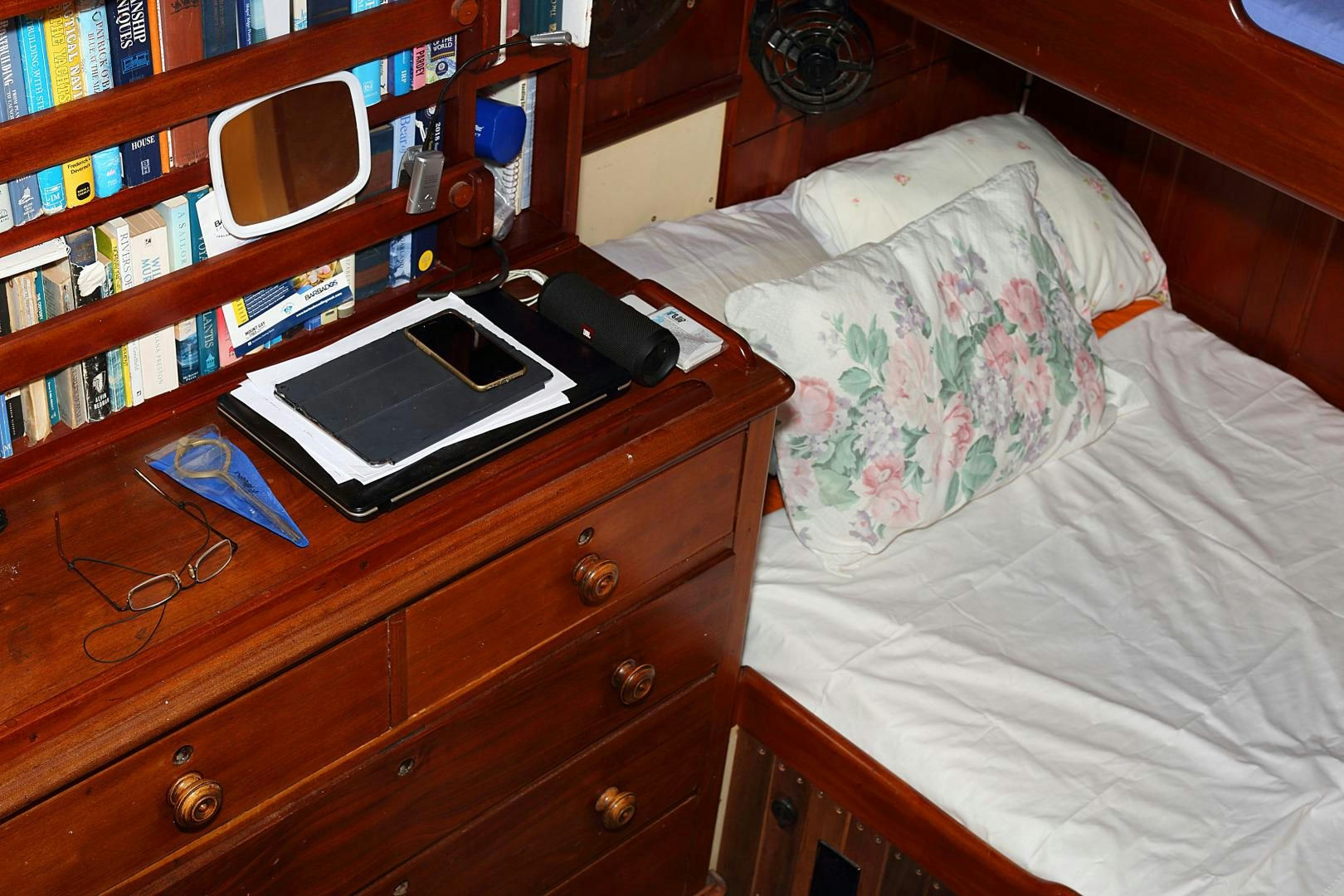 a bed with a television and a book shelf aboard SCHOONER RUTH Yacht for Sale