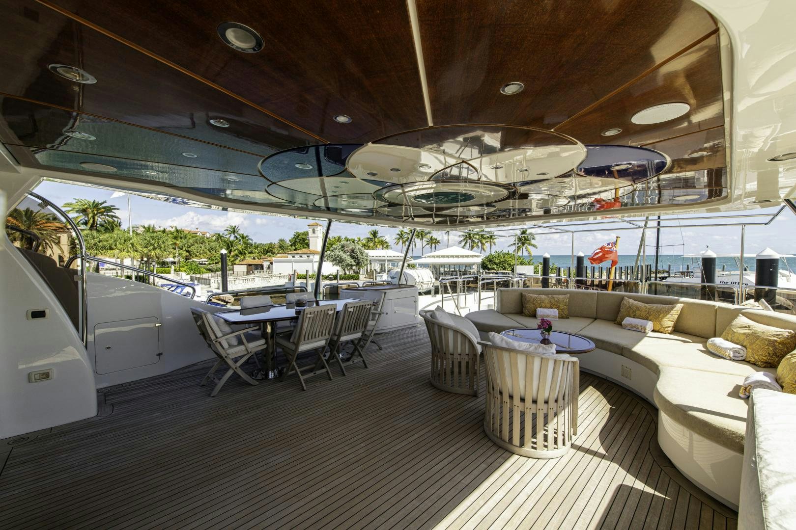 a large room with a table and chairs and a large umbrella aboard RUTLI E Yacht for Sale