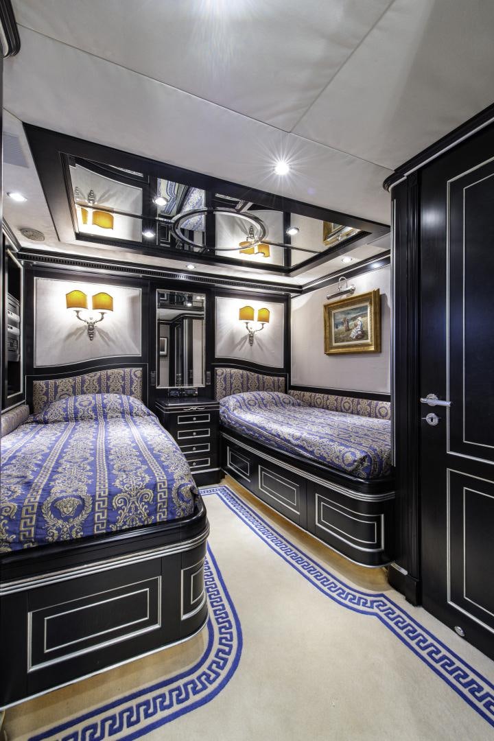 a room with a bed and a mirror aboard RUTLI E Yacht for Sale