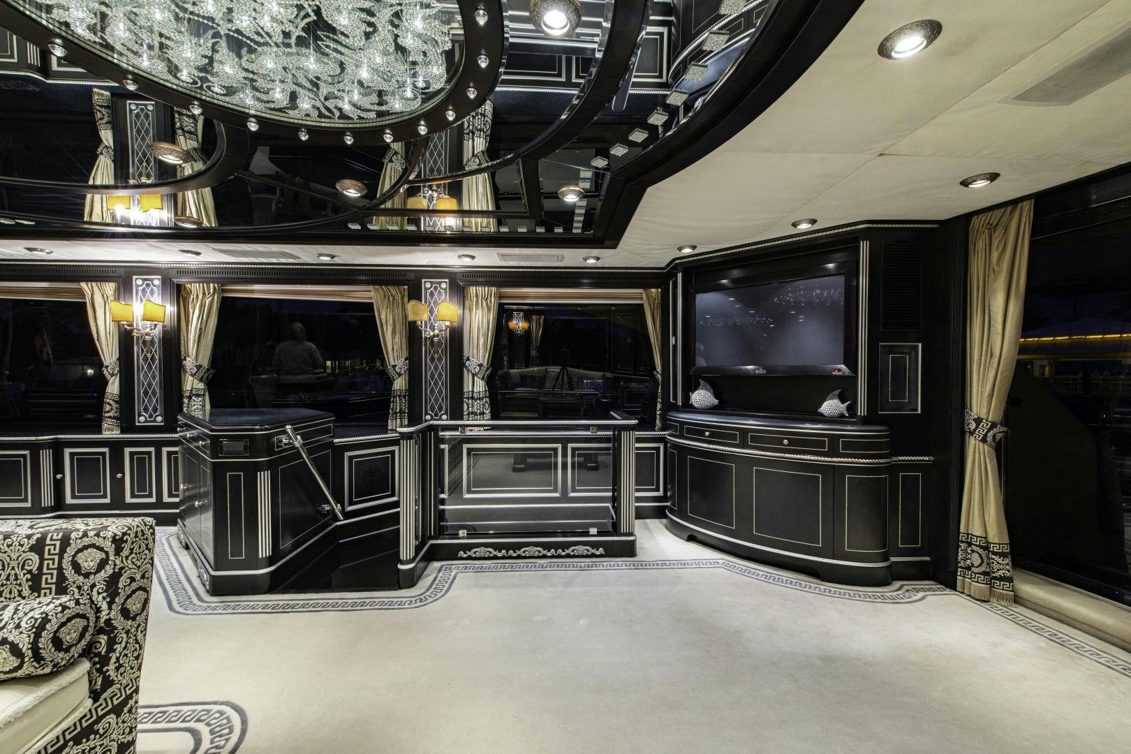 a room with a tv and a table aboard RUTLI E Yacht for Sale