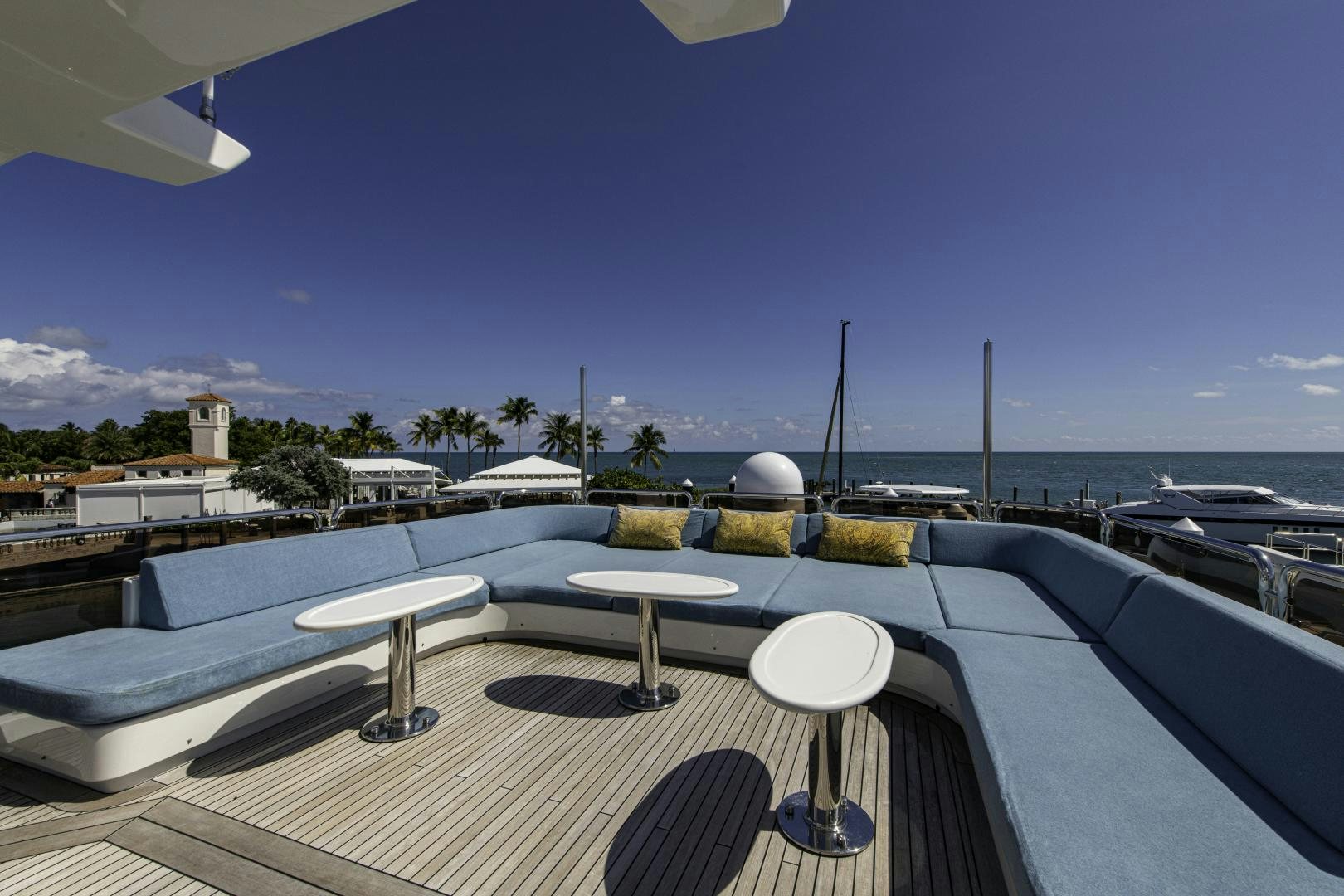 a deck with a table and chairs on it aboard RUTLI E Yacht for Sale