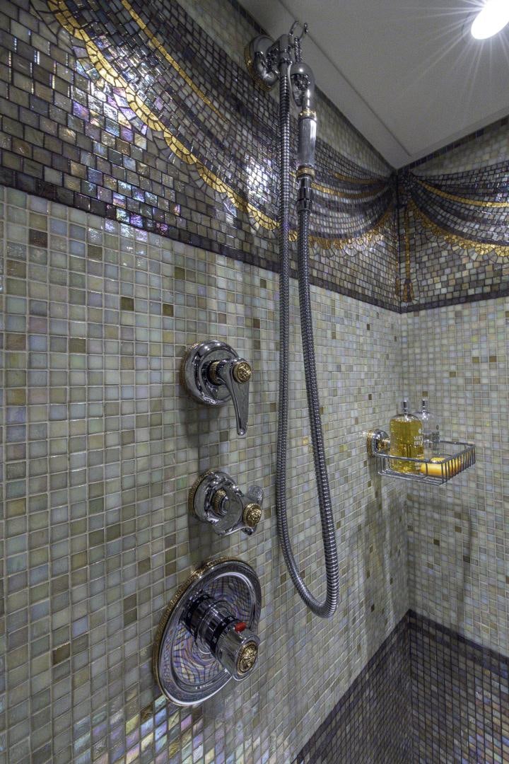 a large metal pipe in a tile room aboard RUTLI E Yacht for Sale