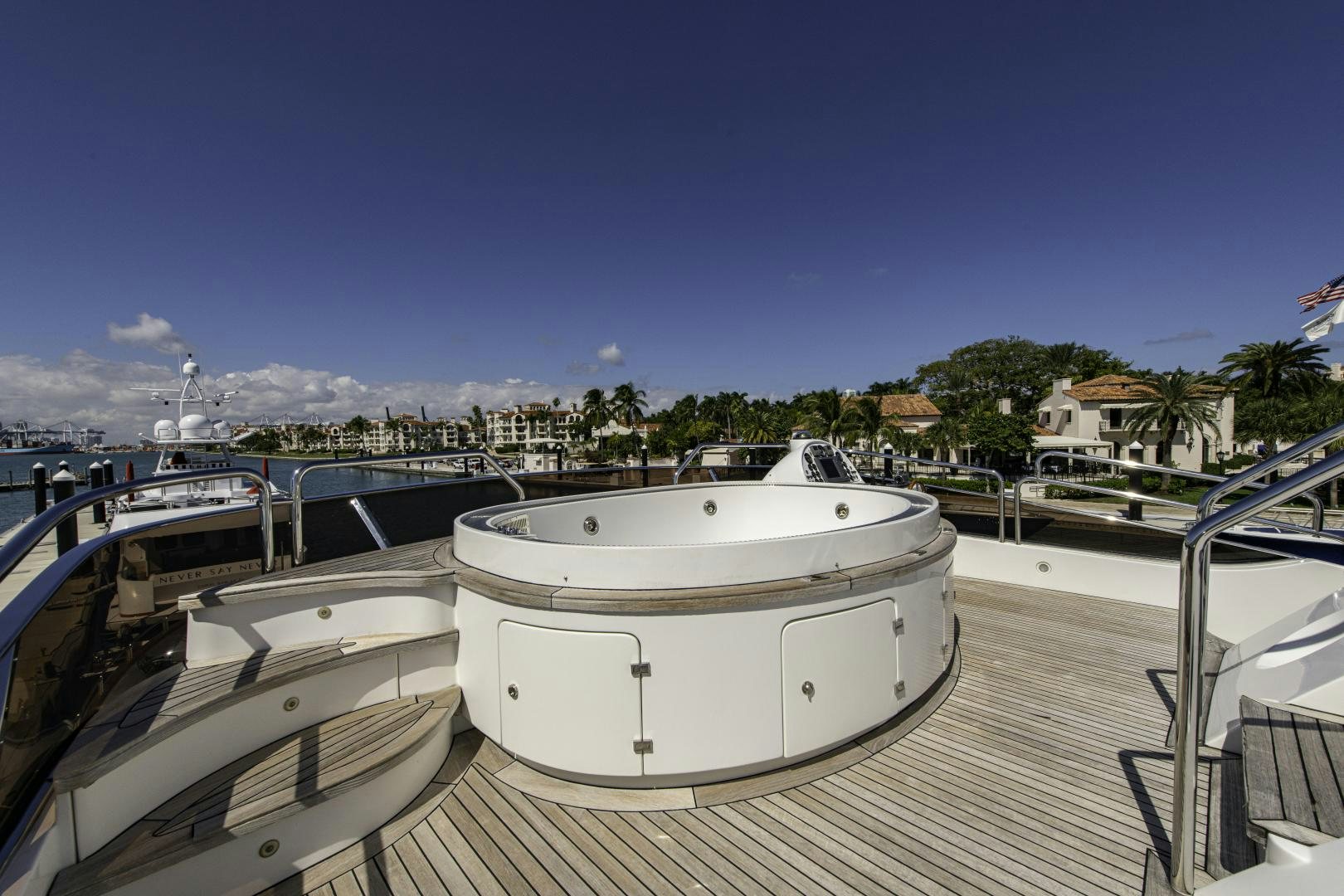 a deck with a white boat on it and buildings in the background aboard RUTLI E Yacht for Sale