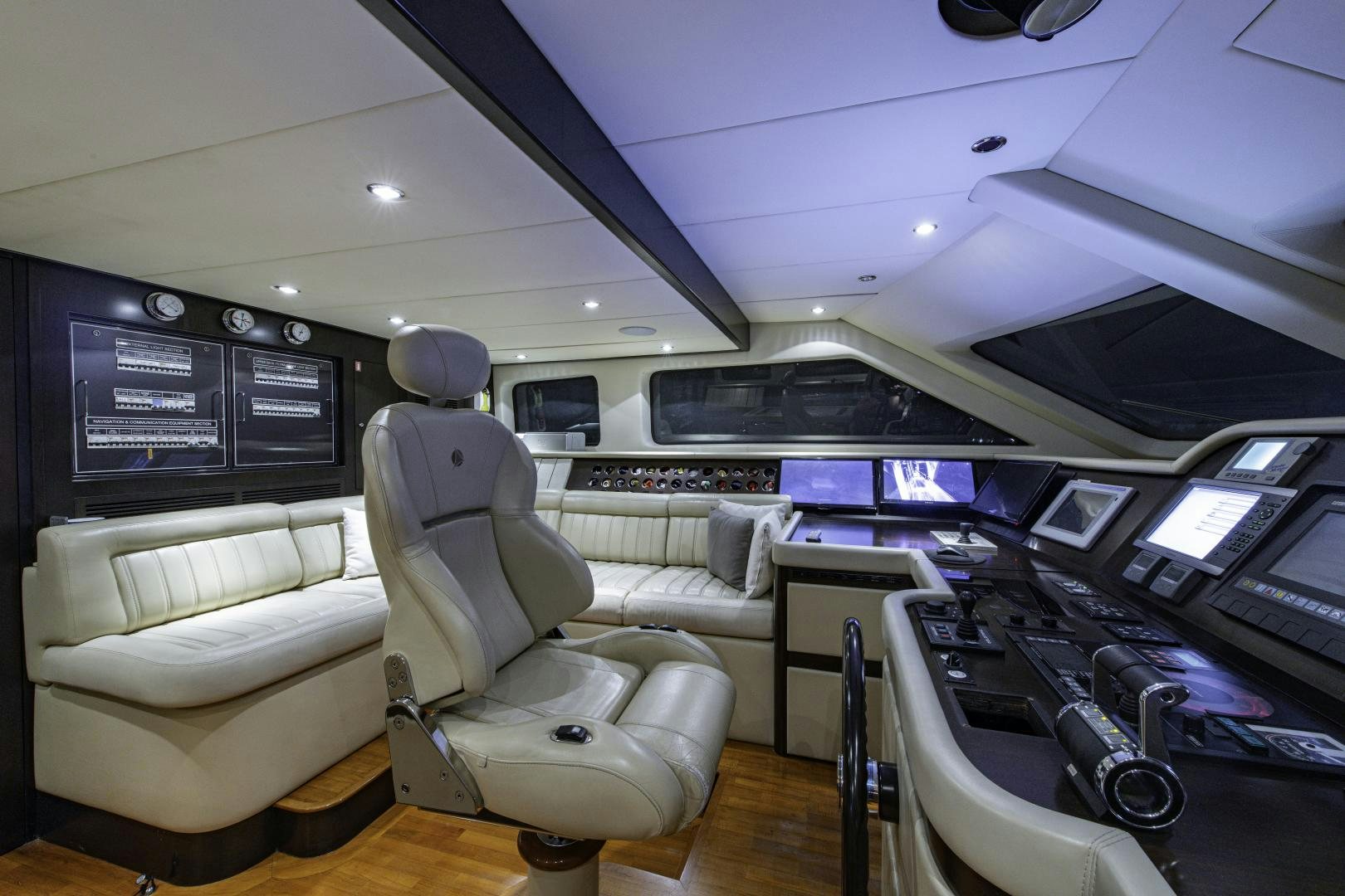 a room with a large desk and chairs and a large screen aboard RUTLI E Yacht for Sale