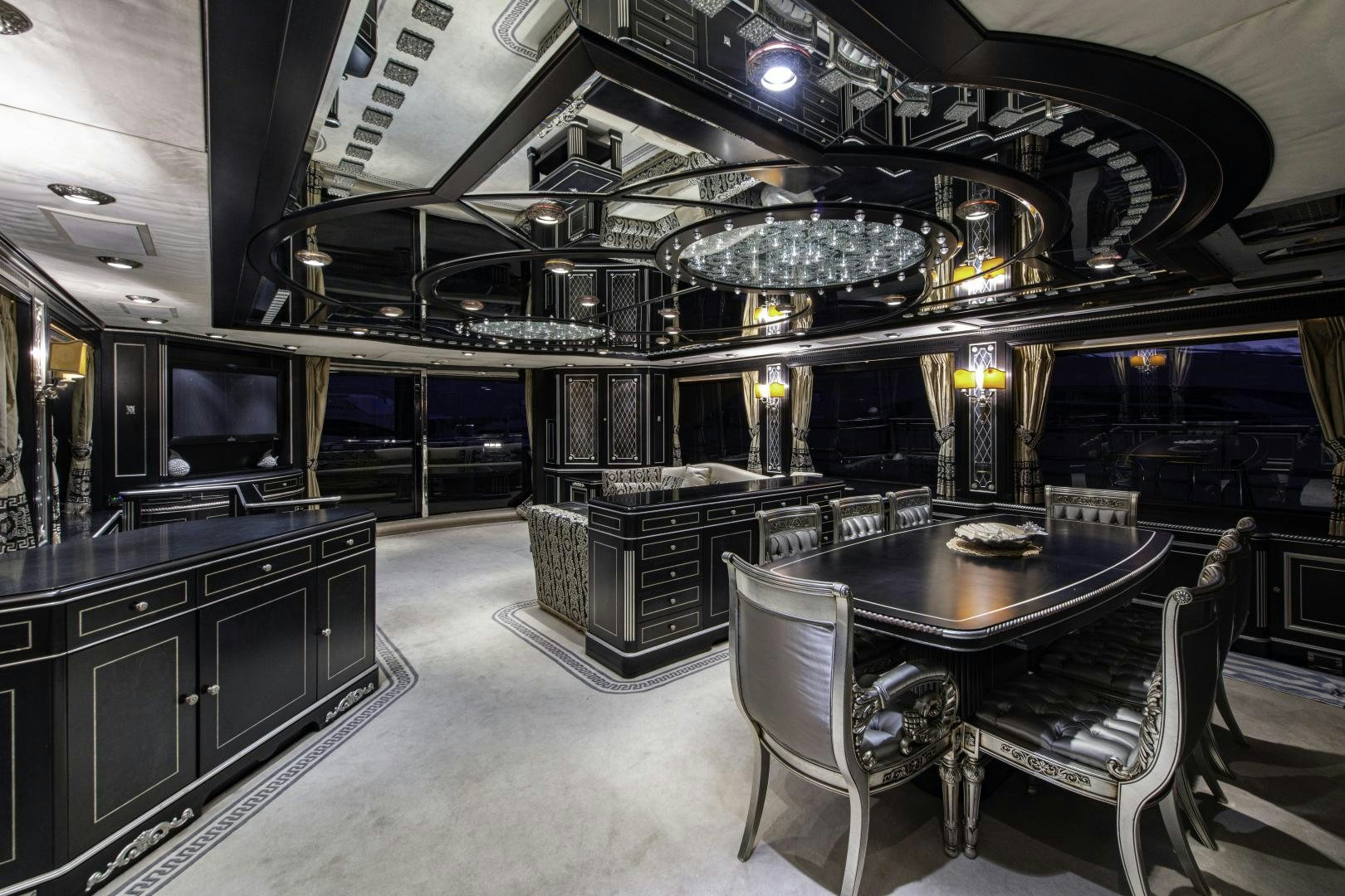 a room with a table chairs and a tv aboard RUTLI E Yacht for Sale