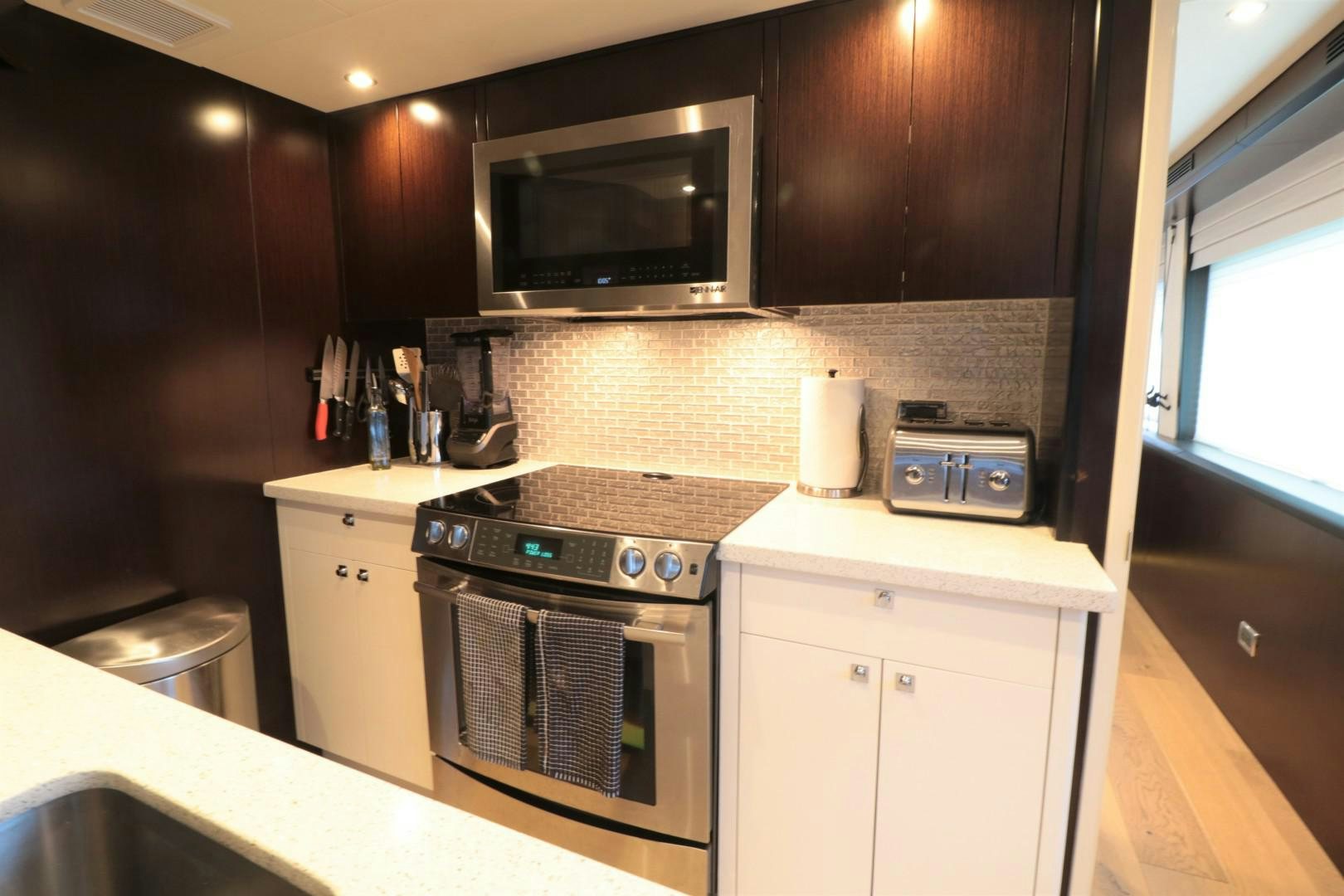 a kitchen with a stove and microwave aboard LADY CARMEN Yacht for Sale
