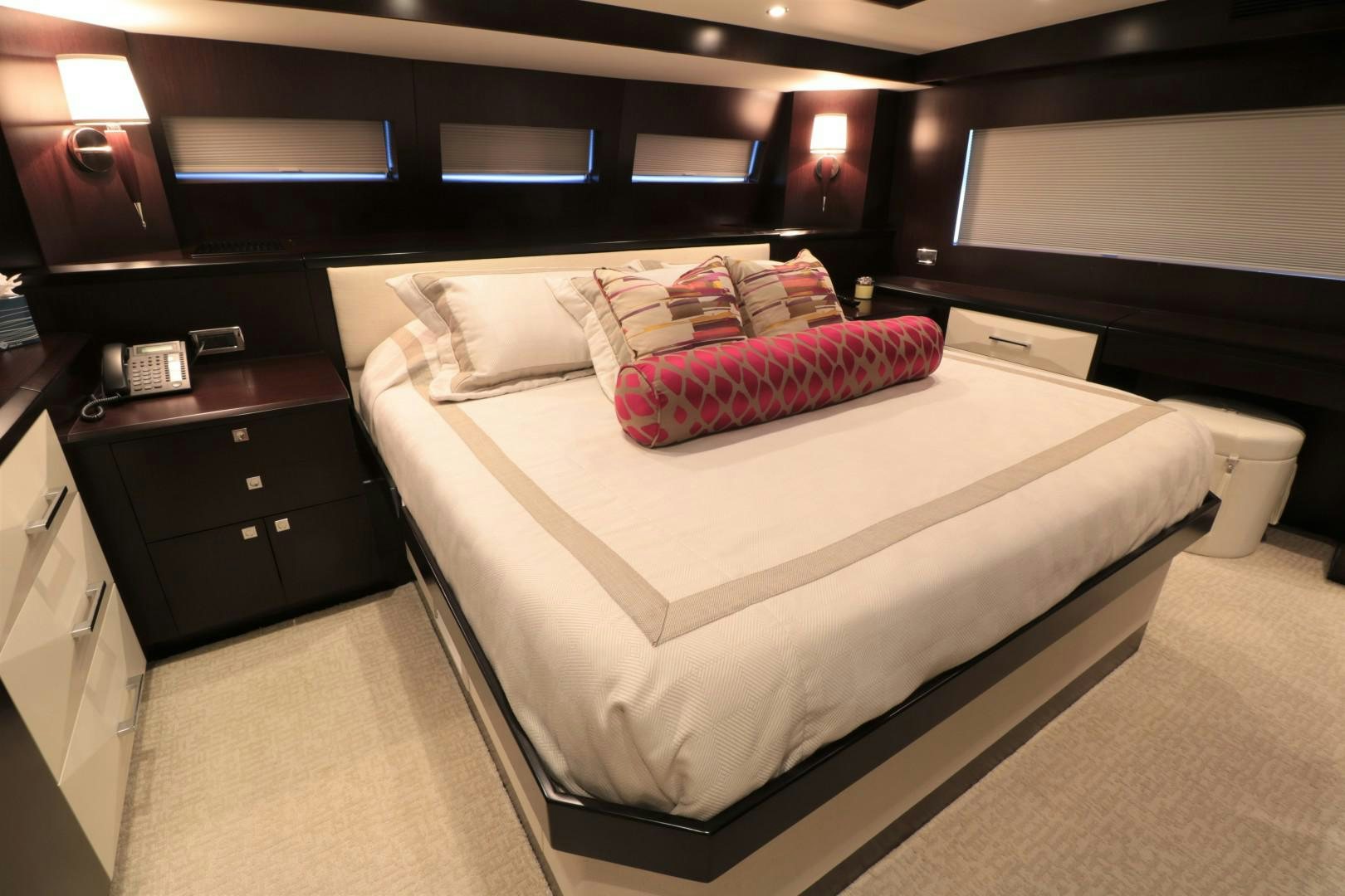 a bed with a red and white pillow on it aboard LADY CARMEN Yacht for Sale