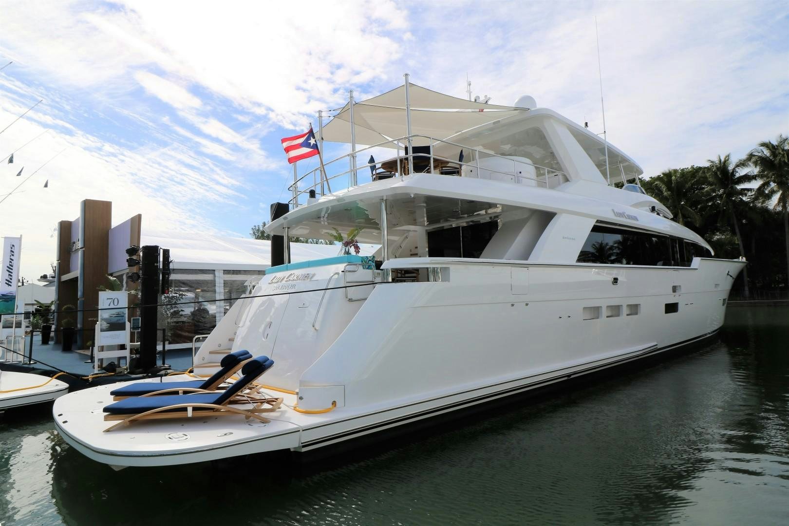 a large white boat in a harbor aboard LADY CARMEN Yacht for Sale