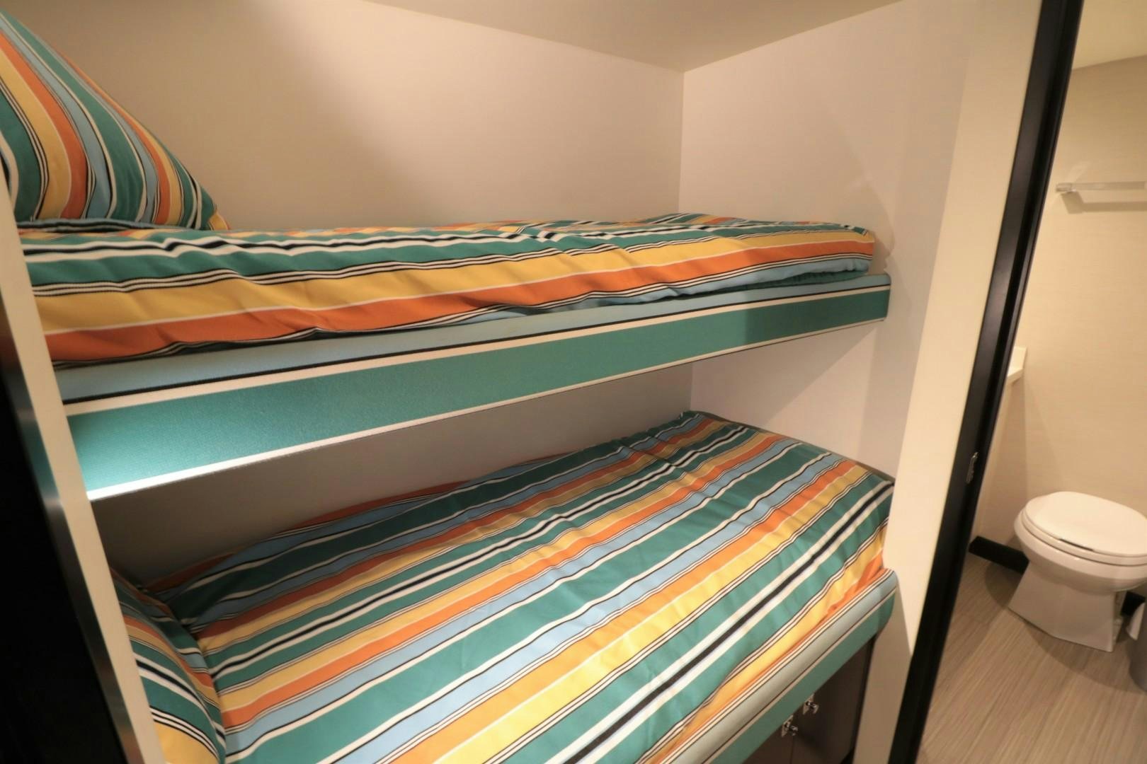 a bed with a colorful comforter aboard LADY CARMEN Yacht for Sale