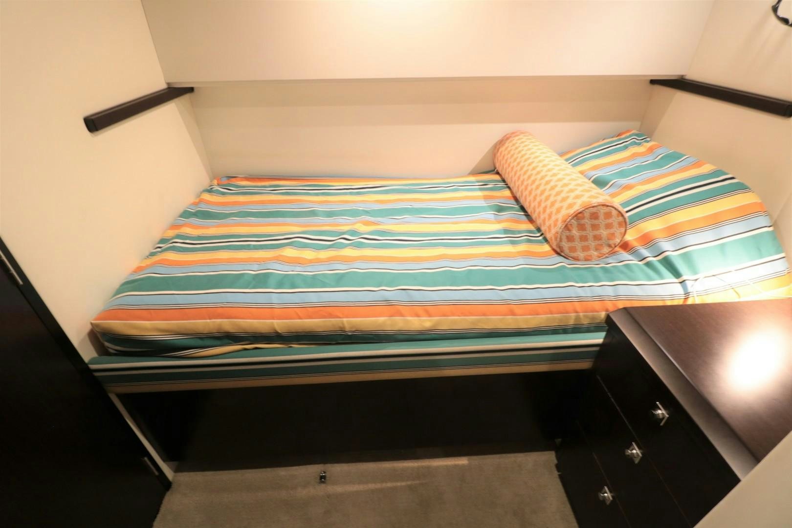 a bed with a colorful blanket aboard LADY CARMEN Yacht for Sale