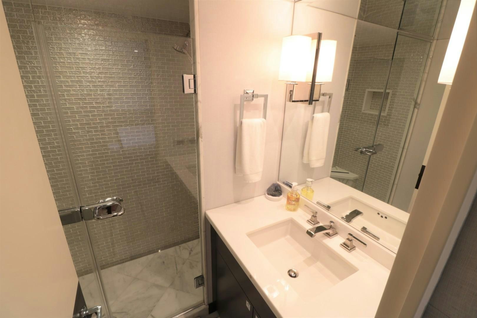 a bathroom with a glass shower aboard LADY CARMEN Yacht for Sale