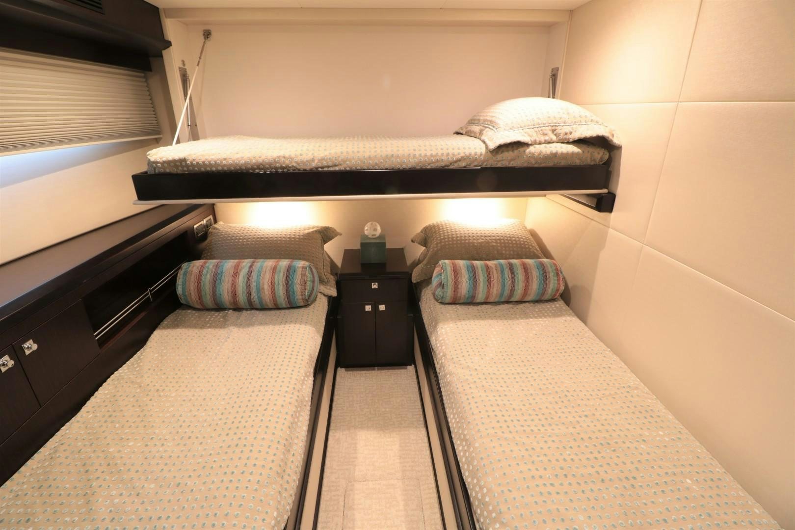 a bed with a black and white bed frame and a black shelf aboard LADY CARMEN Yacht for Sale