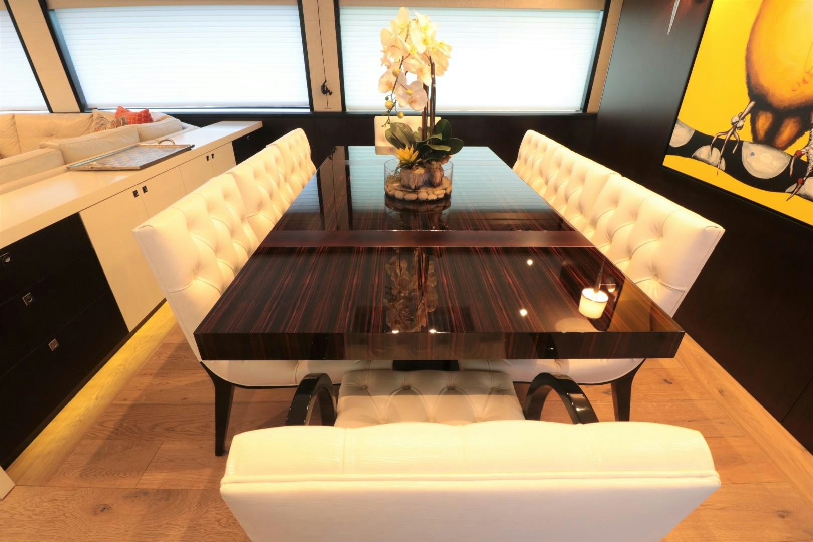 a table with a vase of flowers on it aboard LADY CARMEN Yacht for Sale