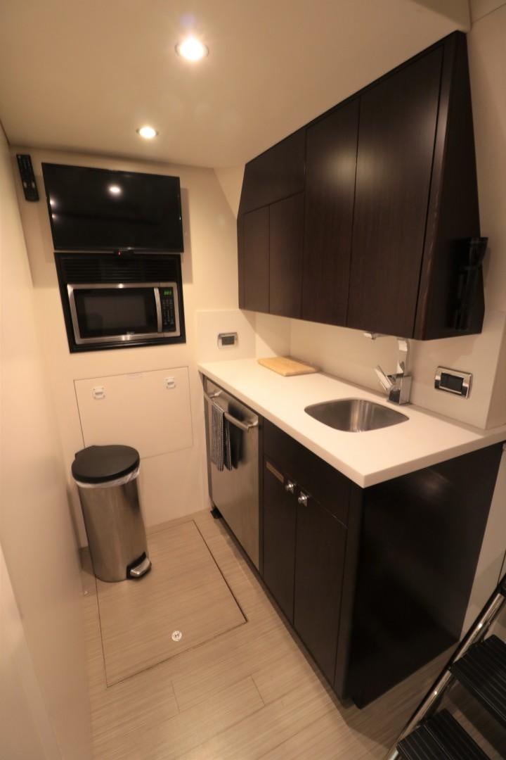 a kitchen with black cabinets aboard LADY CARMEN Yacht for Sale