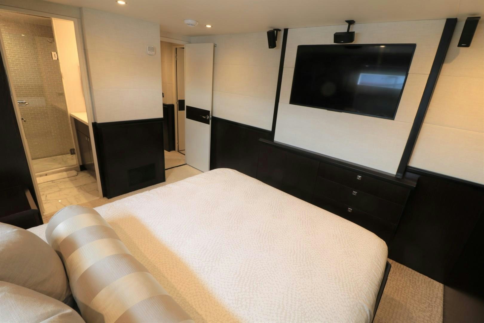 a room with a bed and a tv on the wall aboard LADY CARMEN Yacht for Sale
