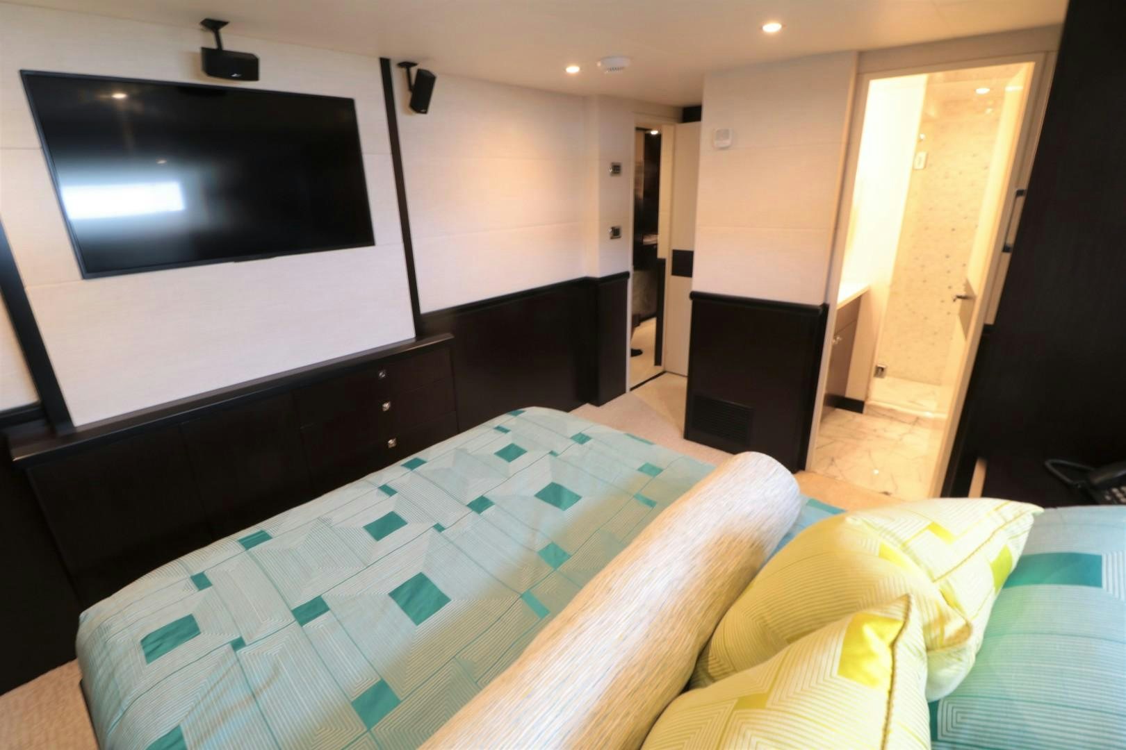 a room with a bed and a tv on the wall aboard LADY CARMEN Yacht for Sale