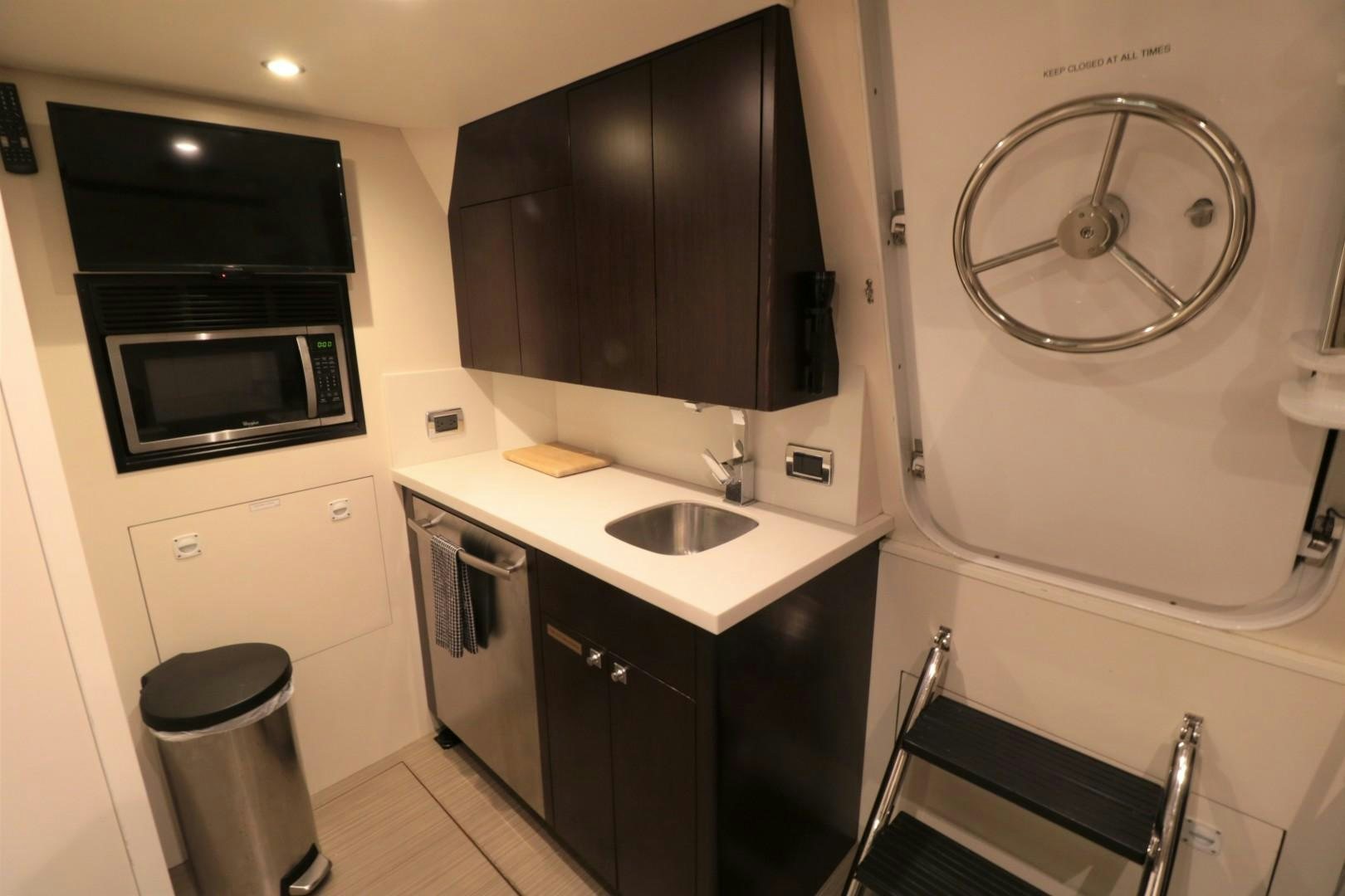 a bathroom with a sink and a microwave aboard LADY CARMEN Yacht for Sale