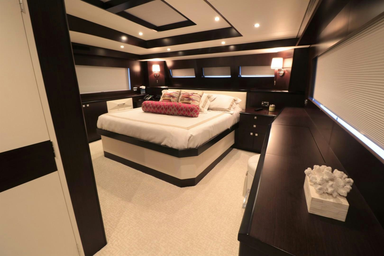 a bedroom with a bed and a desk aboard LADY CARMEN Yacht for Sale