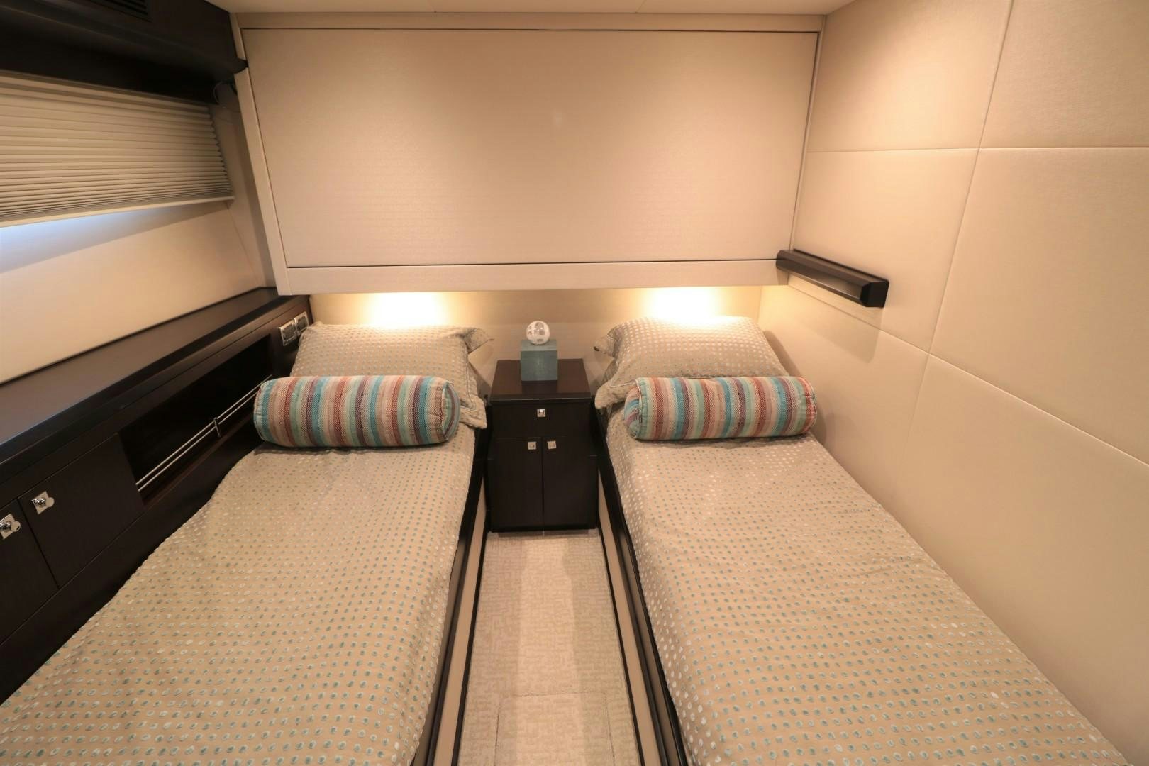 a bed with pillows and a lamp aboard LADY CARMEN Yacht for Sale