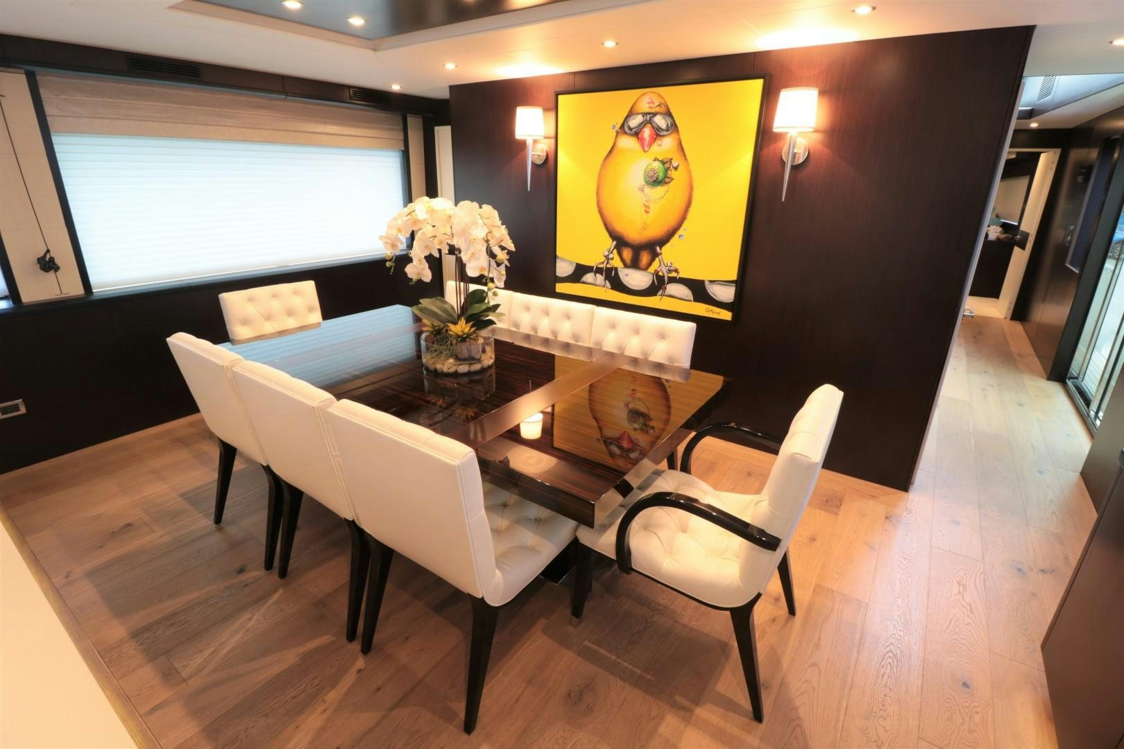 a room with a table and chairs aboard LADY CARMEN Yacht for Sale