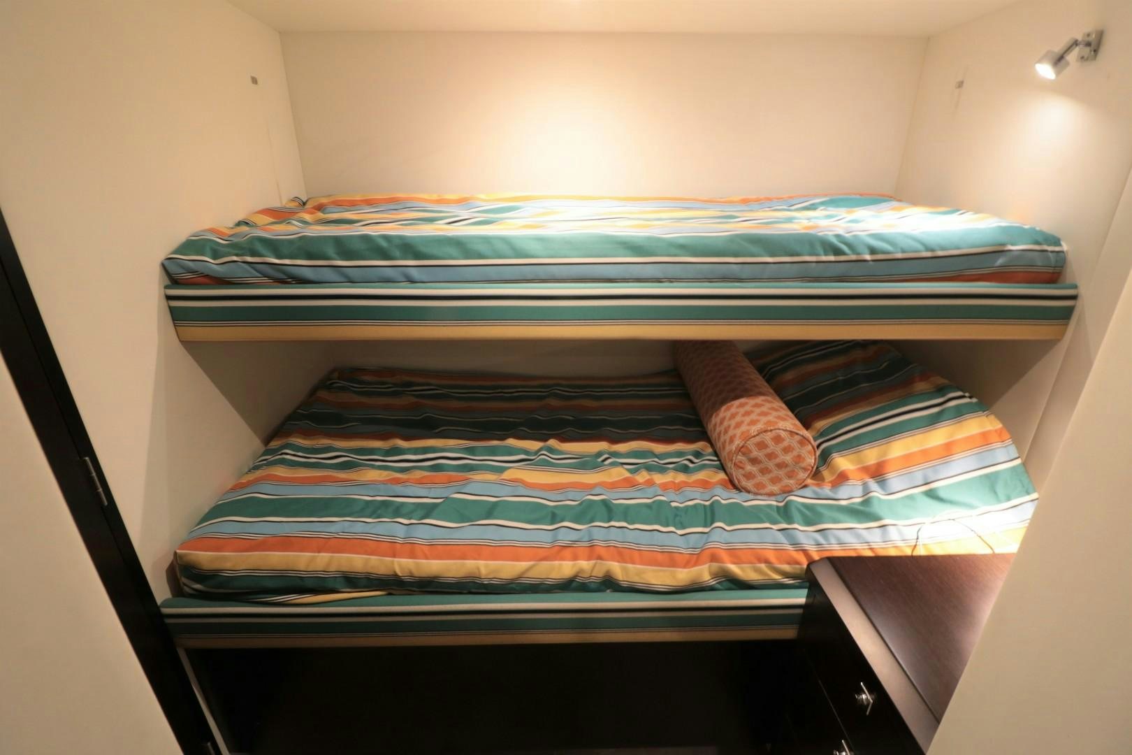 a bed with a colorful blanket aboard LADY CARMEN Yacht for Sale