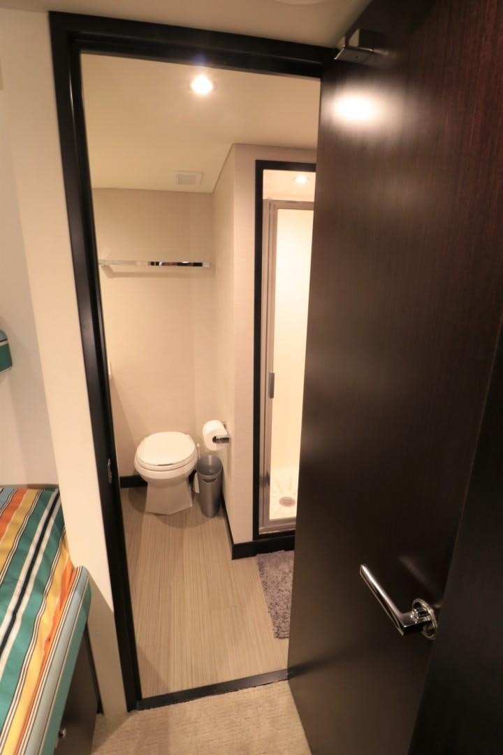 a bathroom with a toilet and a door aboard LADY CARMEN Yacht for Sale