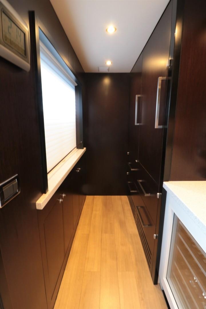 a hallway with a wood floor and black cabinets aboard LADY CARMEN Yacht for Sale