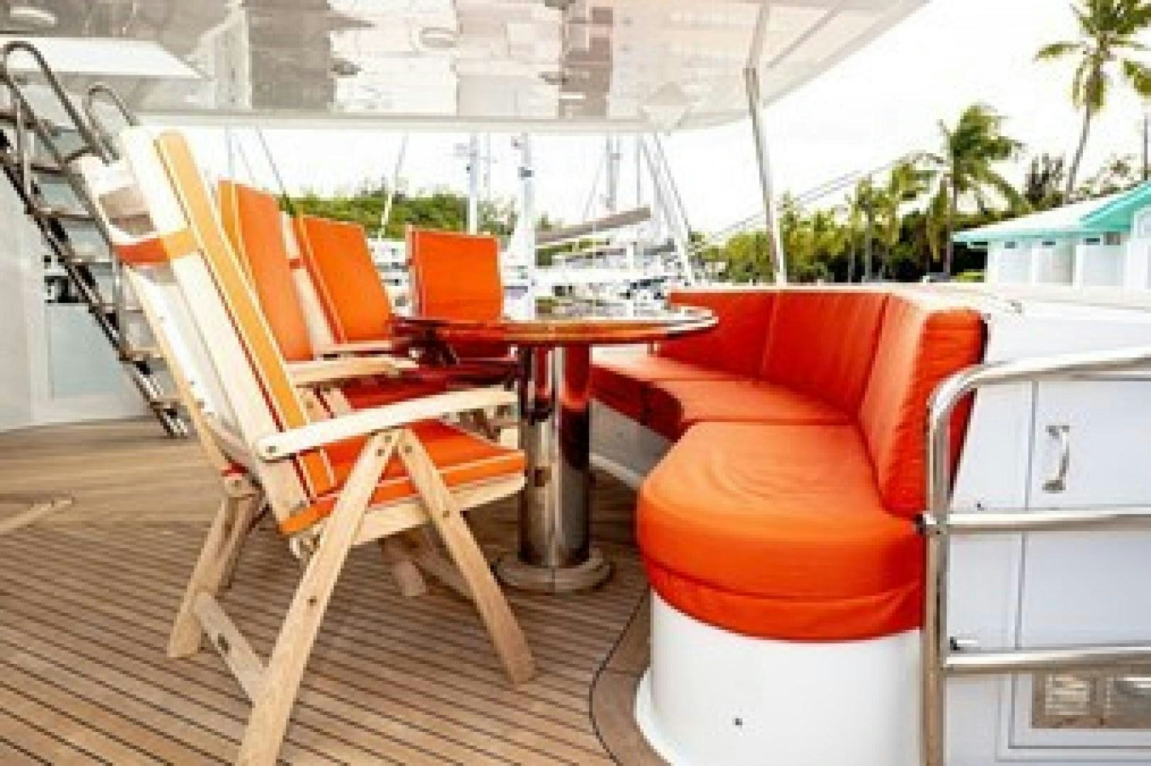 chairs and tables outside aboard TAIMA Yacht for Sale