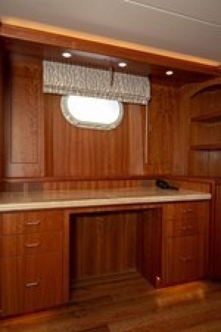 a kitchen with wooden cabinets aboard TAIMA Yacht for Sale