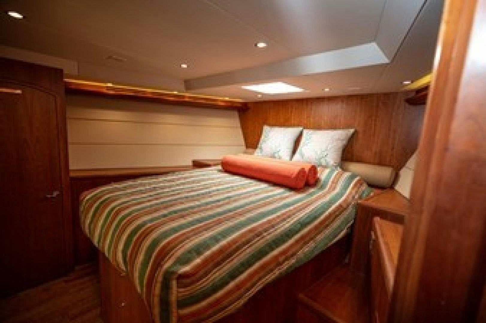 a bed in a room aboard TAIMA Yacht for Sale
