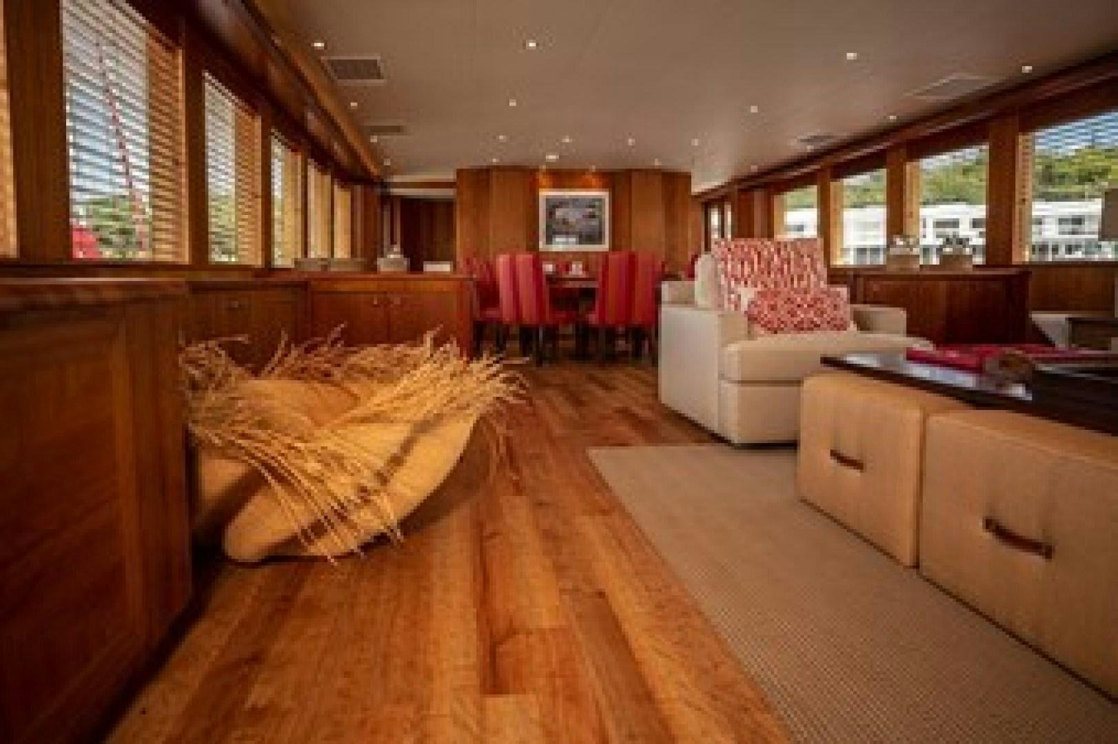 a living room with a couch and a table aboard TAIMA Yacht for Sale