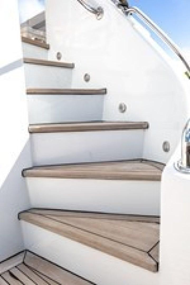 a white staircase with a railing aboard TAIMA Yacht for Sale