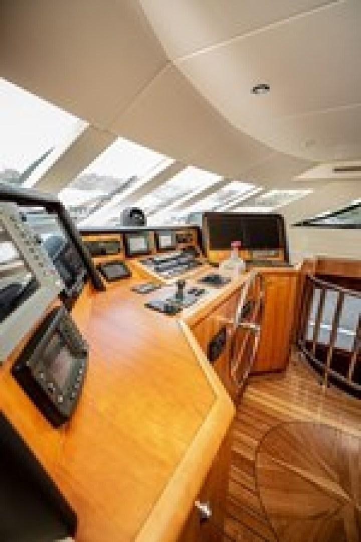 a room with a large table and tv aboard TAIMA Yacht for Sale