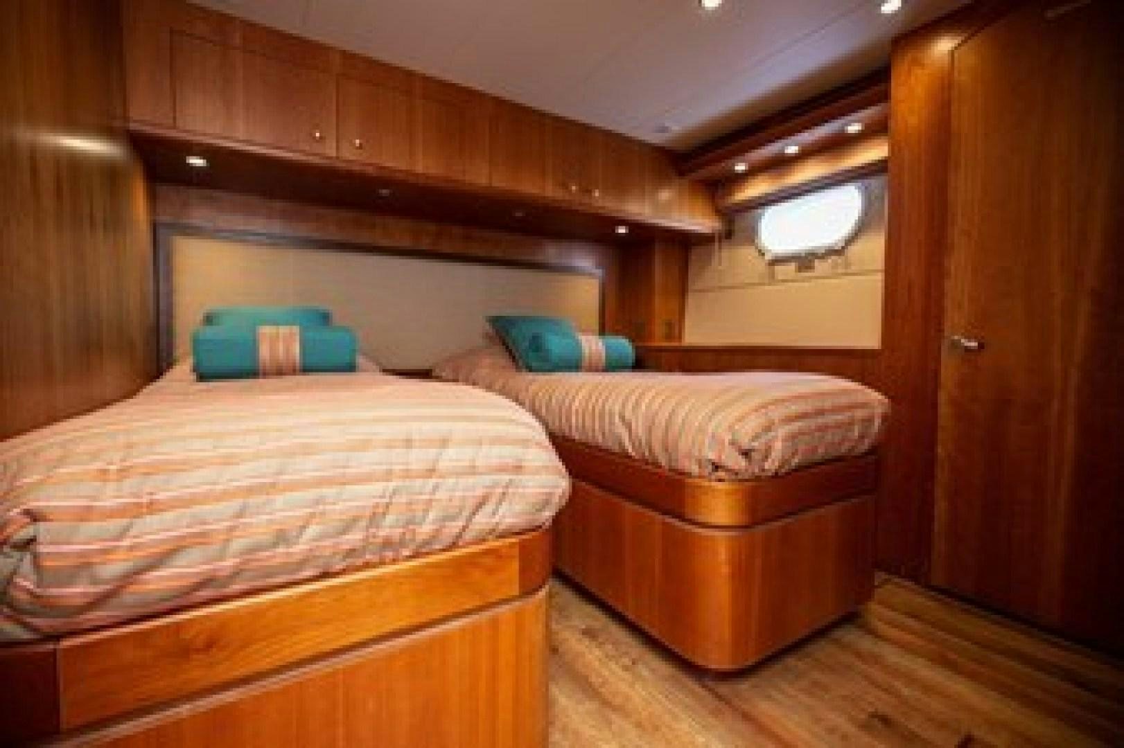 a room with two beds aboard TAIMA Yacht for Sale