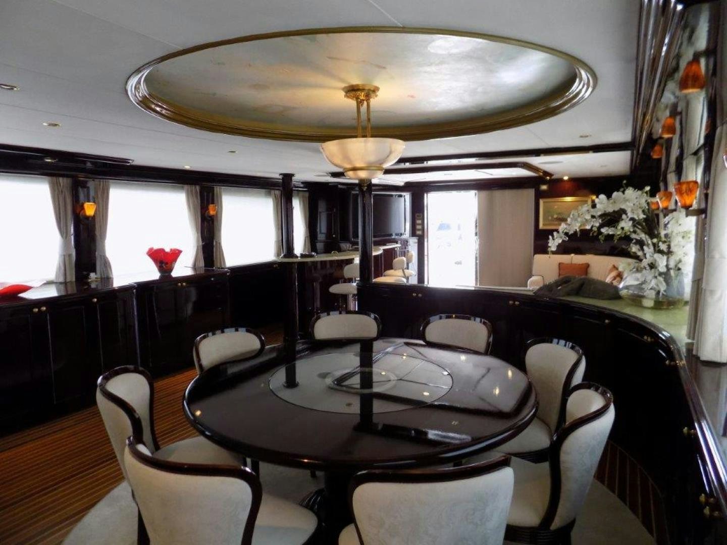 a dining room with a chandelier above it aboard BENDIS Yacht for Sale