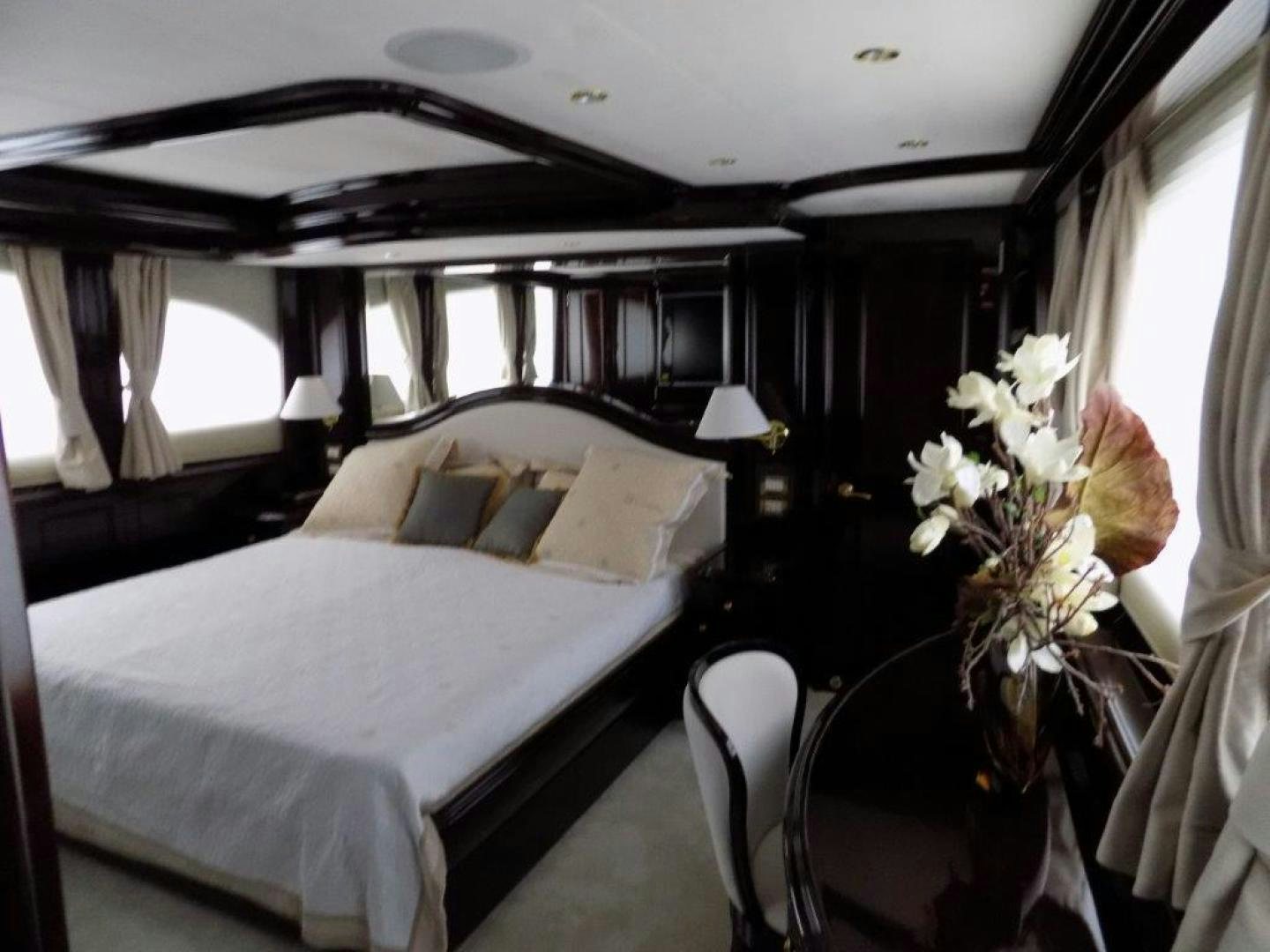 a bed with white sheets and pillows aboard BENDIS Yacht for Sale