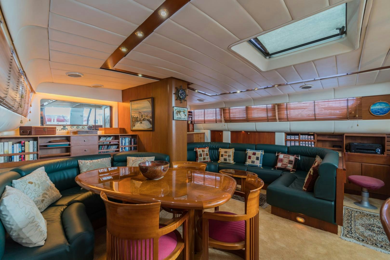 a living room with a couch and a table aboard TARONGA Yacht for Sale