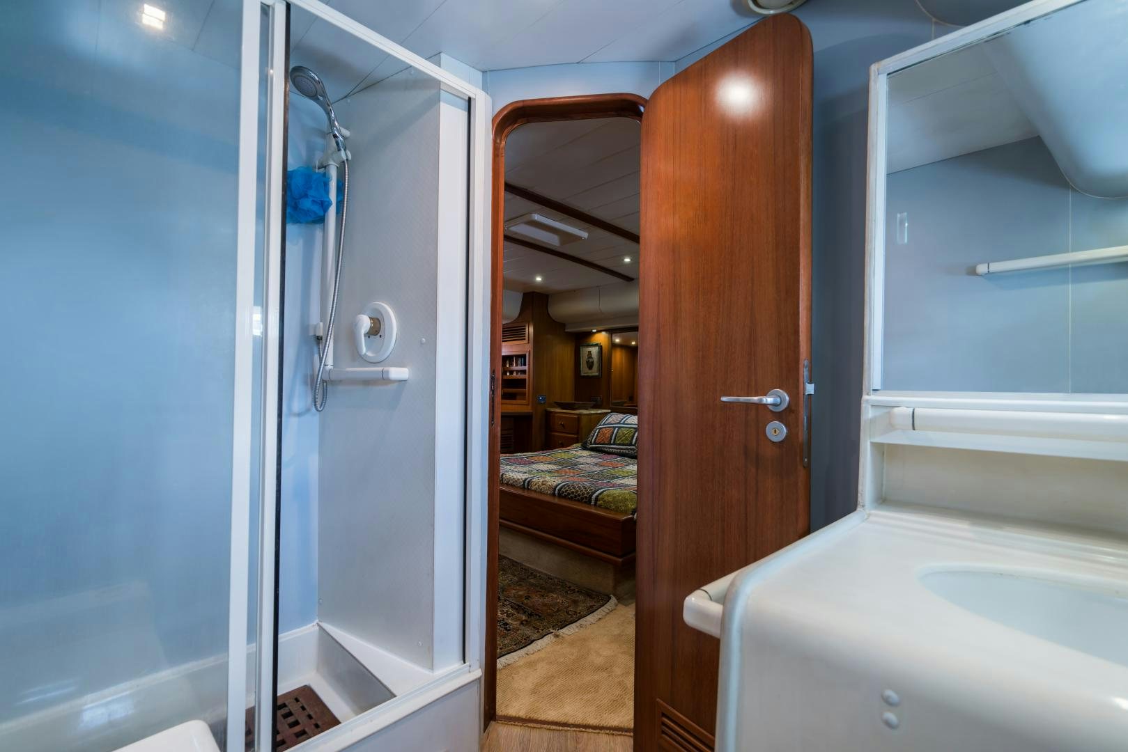 a room with a door and a mirror aboard TARONGA Yacht for Sale
